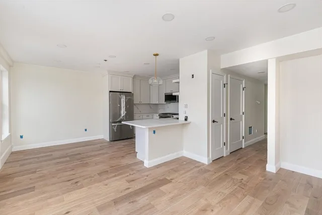 a view of kitchen with wooden floor