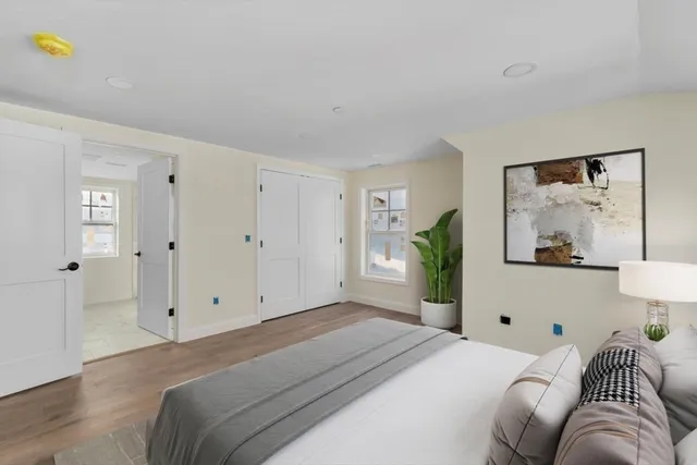 a bedroom with a bed and painting on the wall