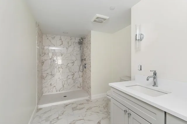 a bathroom with a shower and a sink