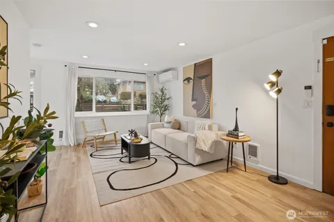 a living room with furniture and a potted plant