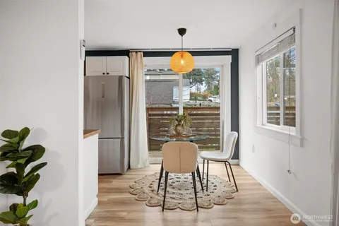 a view of a dining room with furniture window and wooden floor