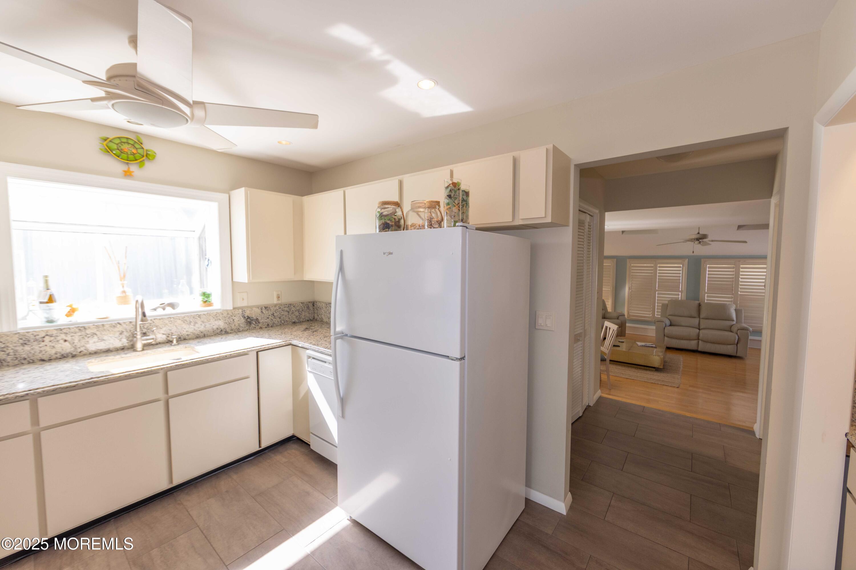 5 Hunter Drive Little Egg Harbor, NJ 08087 - Photo 23 of 76 a kitchen with a refrigerator a sink and dishwasher with white cabinets