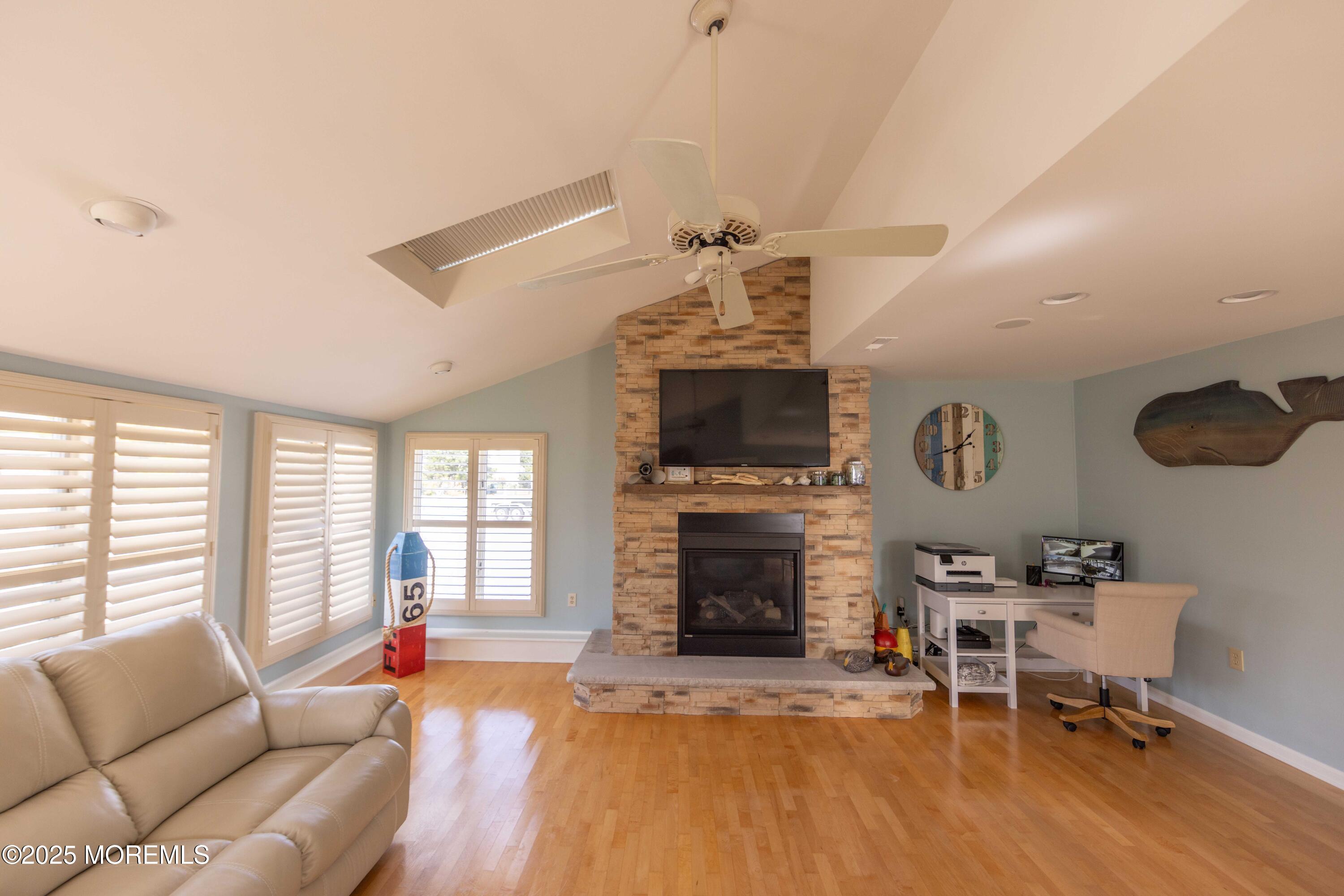 5 Hunter Drive Little Egg Harbor, NJ 08087 - Photo 32 of 76 a living room with furniture a fireplace and a flat screen tv
