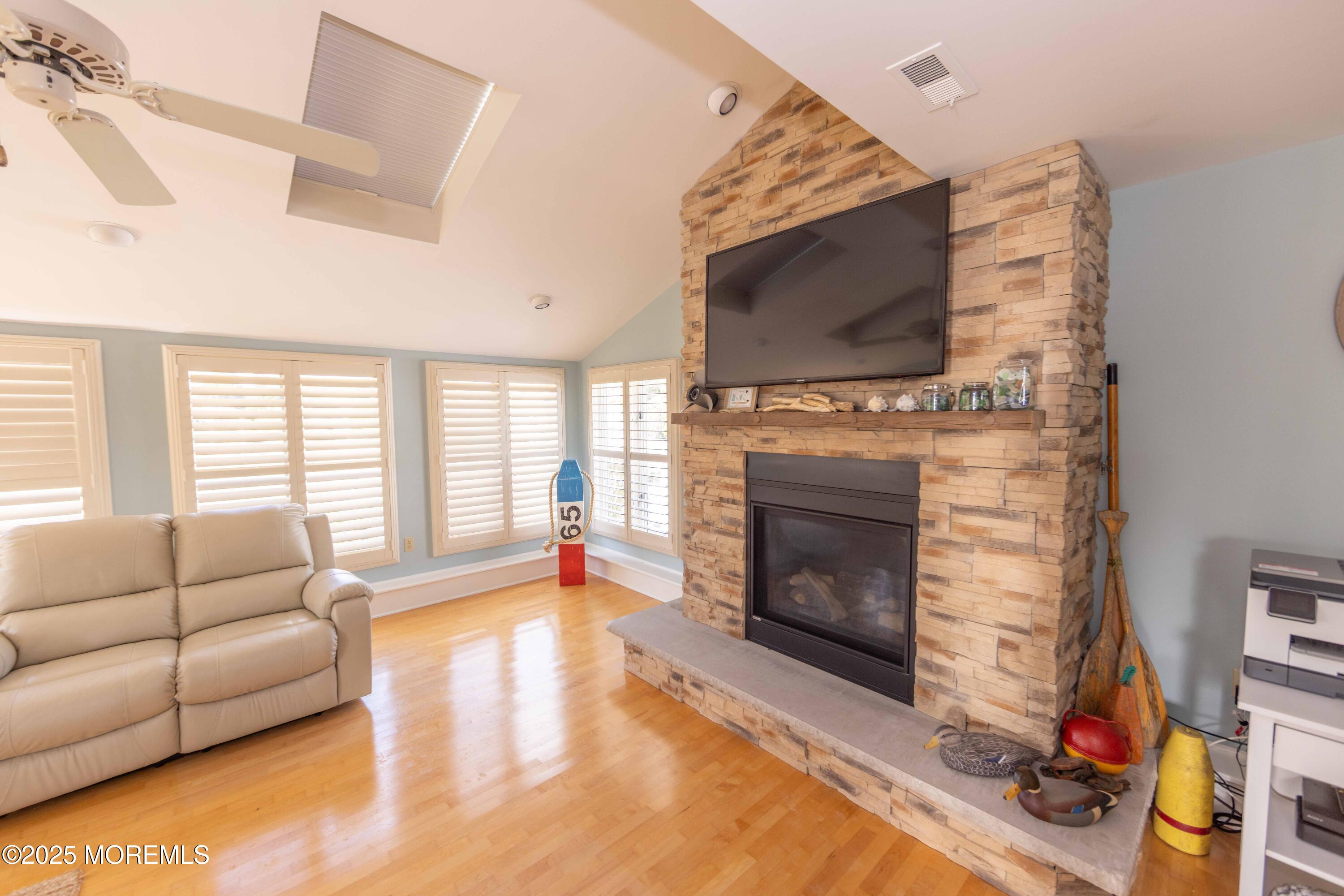 5 Hunter Drive Little Egg Harbor, NJ 08087 - Photo 34 of 76 a living room with furniture a flat screen tv and a fireplace