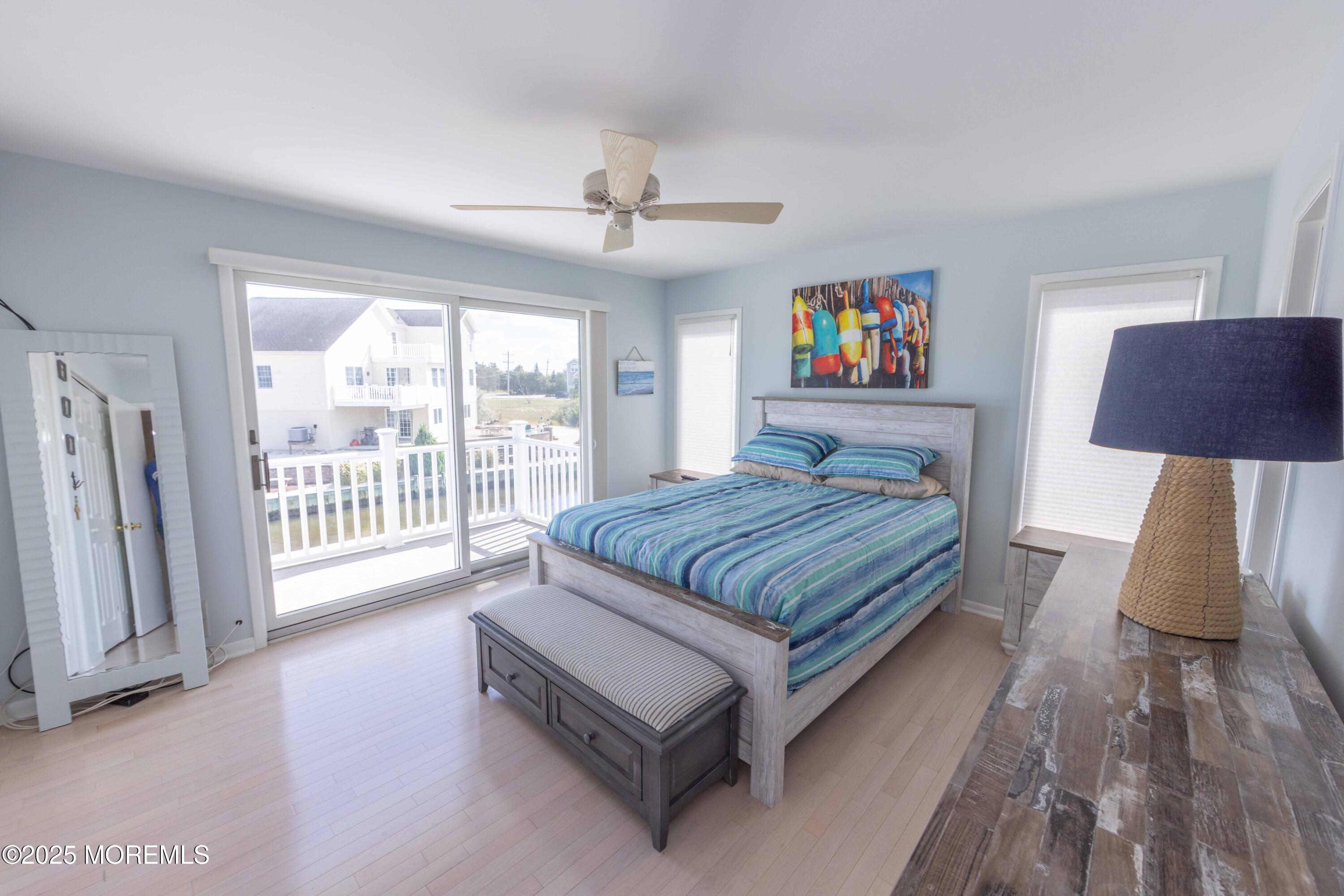 5 Hunter Drive Little Egg Harbor, NJ 08087 - Photo 38 of 76 a spacious bedroom with a large bed a chandelier and a window