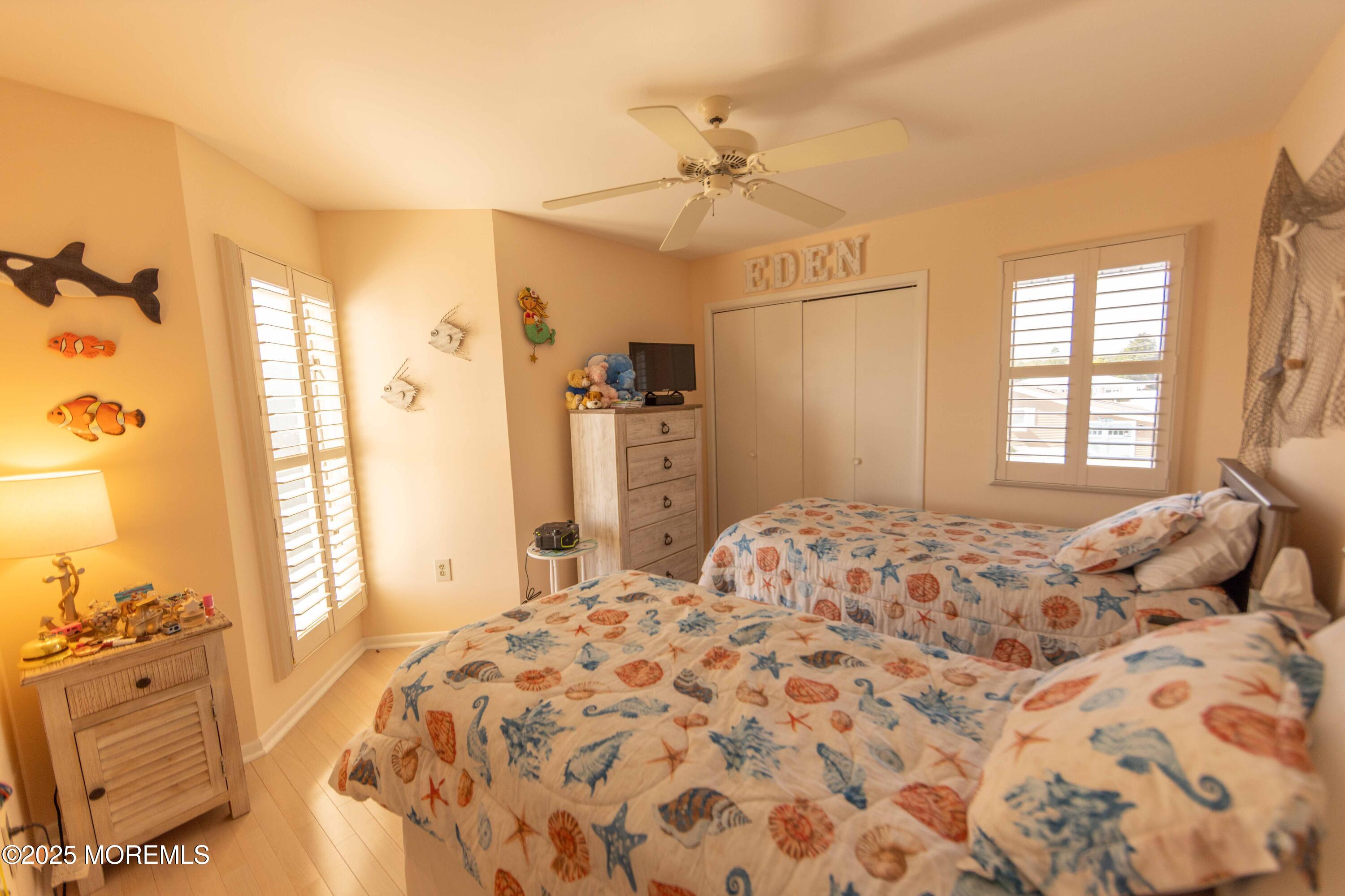 5 Hunter Drive Little Egg Harbor, NJ 08087 - Photo 43 of 76 a bedroom with a bed and a chandelier