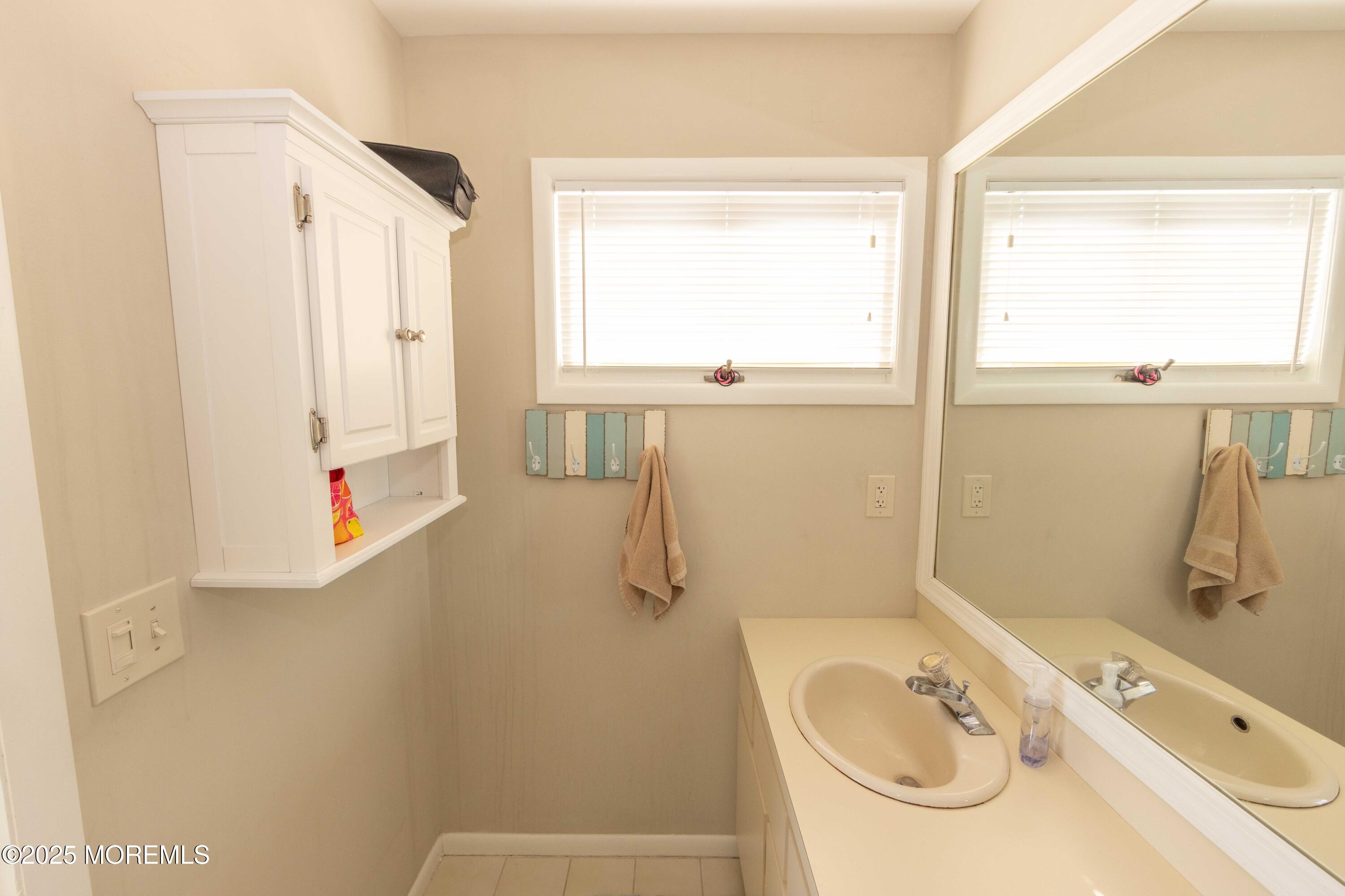 5 Hunter Drive Little Egg Harbor, NJ 08087 - Photo 45 of 76 a bathroom with a tub sink vanity and mirror