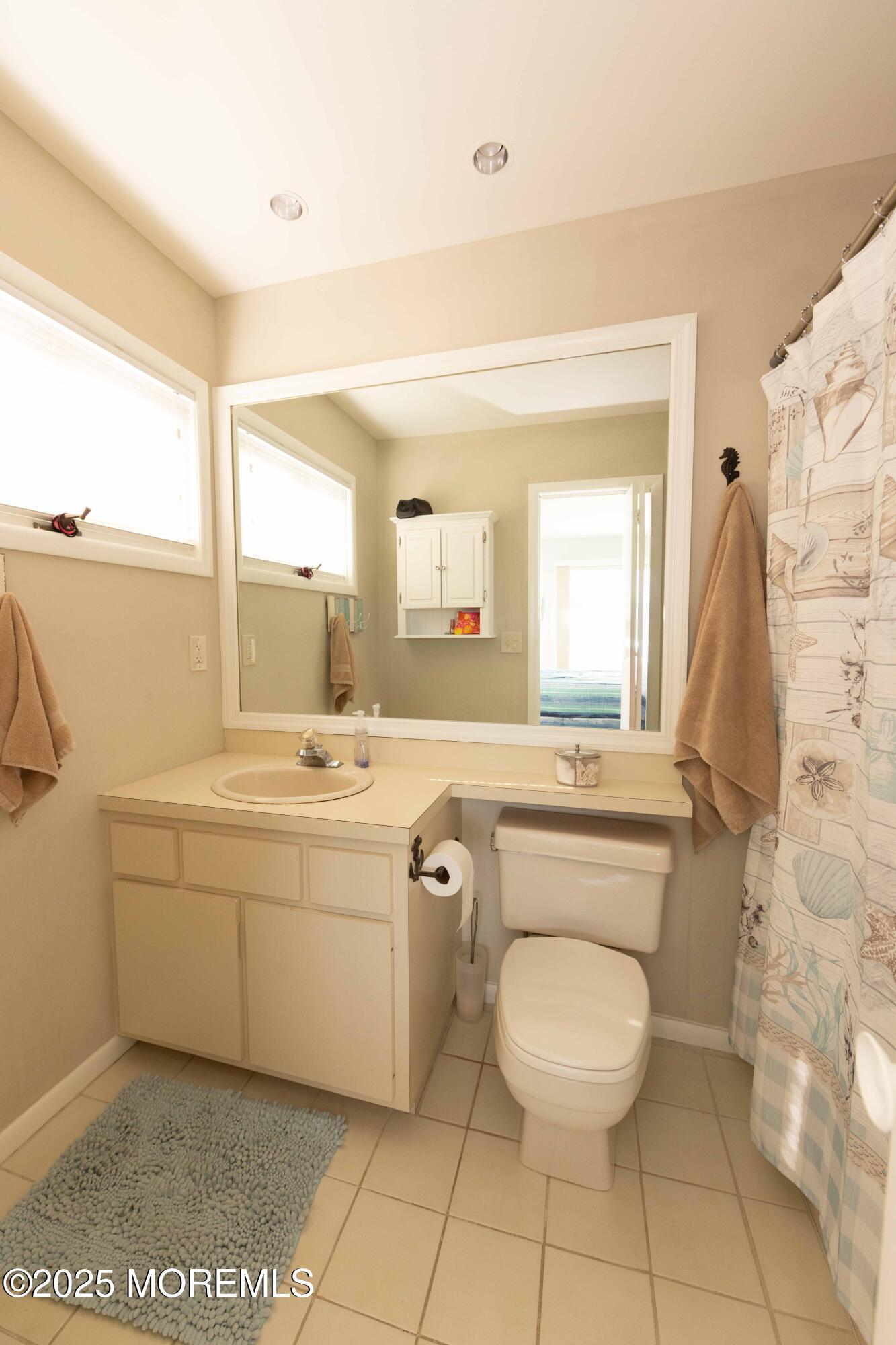 5 Hunter Drive Little Egg Harbor, NJ 08087 - Photo 47 of 76 a spacious bathroom with a toilet sink and mirror