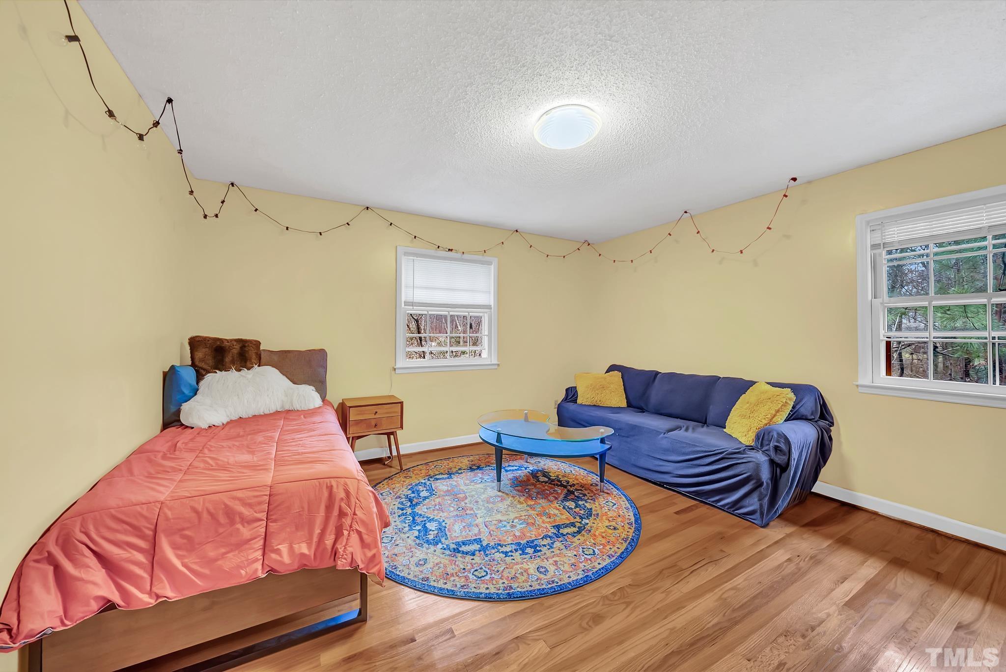 8604 Evergreen Court Raleigh, NC 27613 - Photo 23 of 40 a living room with furniture and a wooden floor