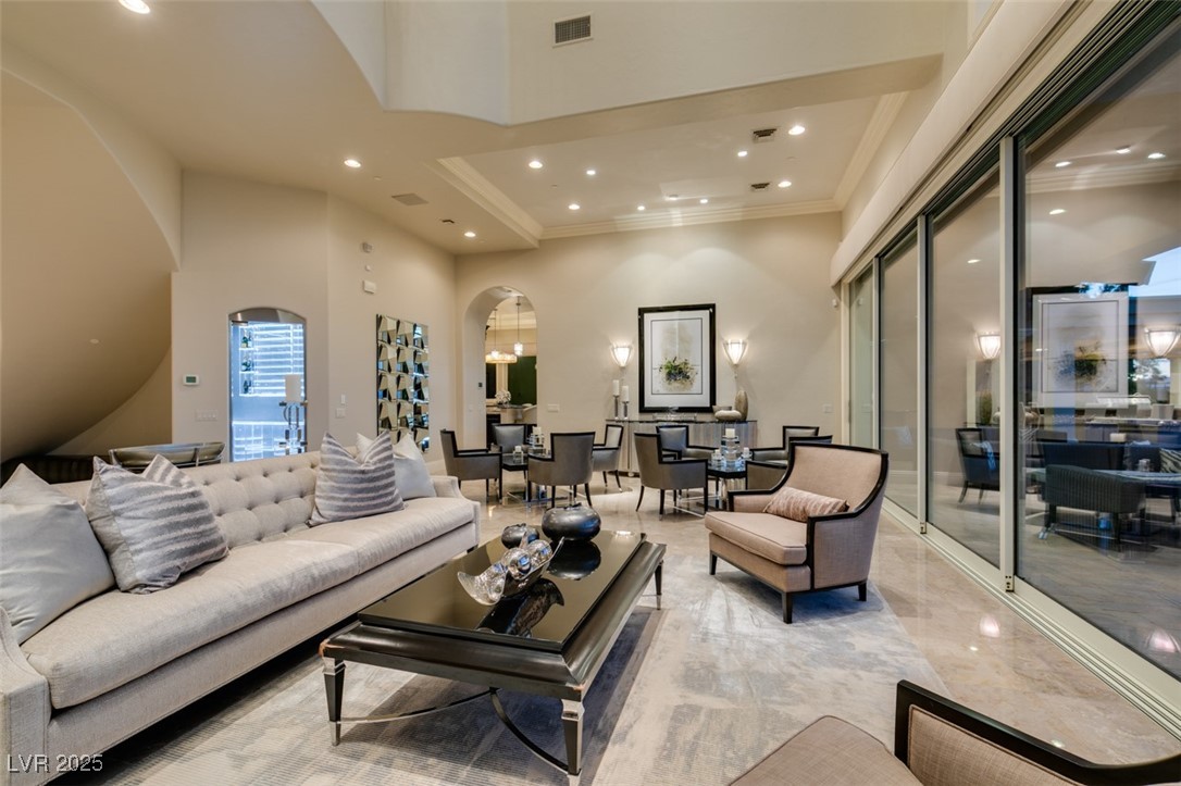 4 Awbrey Court Henderson, NV 89052 - Photo 11 of 72 Living room with a high ceiling, recessed lighting, arched walkways, and a tray ceiling