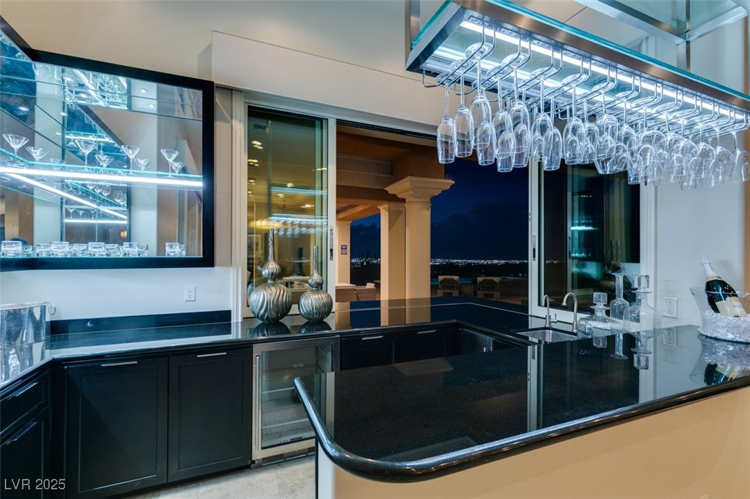 4 Awbrey Court Henderson, NV 89052 - Photo 14 of 72 Indoor wet bar featuring wine cooler, dark cabinetry, and dark stone counters