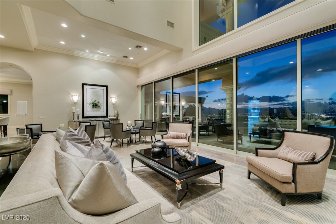 4 Awbrey Court Henderson, NV 89052 - Photo 2 of 72 Living area with arched walkways, recessed lighting, a high ceiling, and ornamental molding
