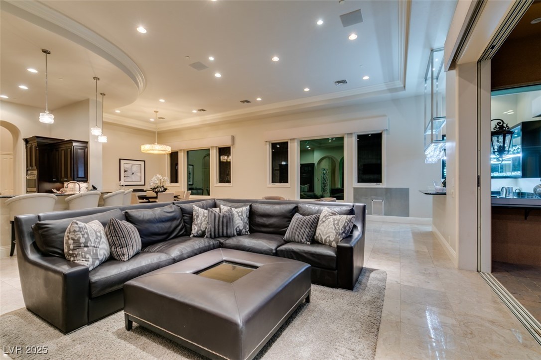4 Awbrey Court Henderson, NV 89052 - Photo 26 of 72 Living area with recessed lighting, ornamental molding, a raised ceiling, and arched walkways