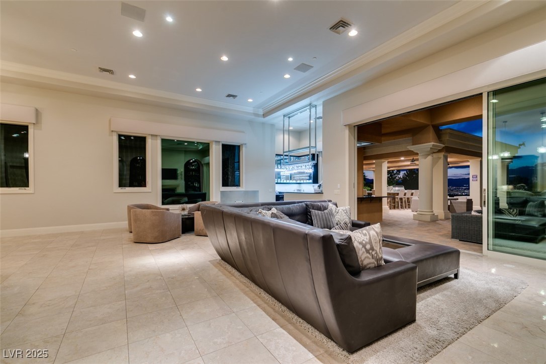 4 Awbrey Court Henderson, NV 89052 - Photo 30 of 72 Living area featuring recessed lighting, ornamental molding, and a raised ceiling