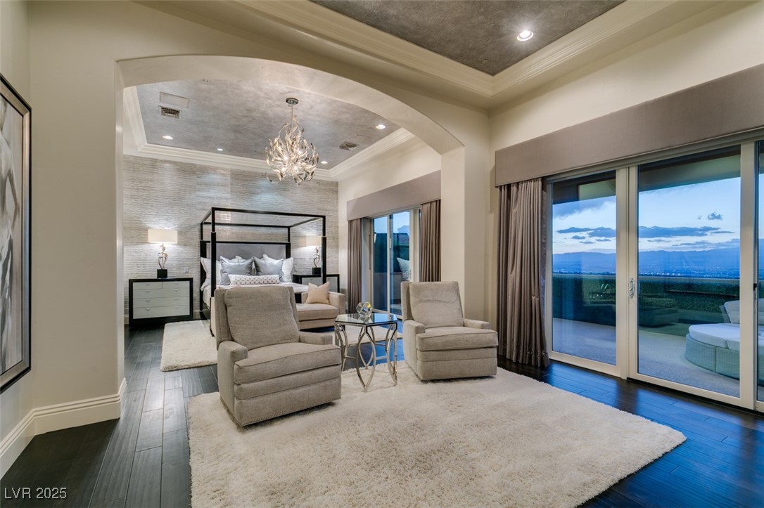 4 Awbrey Court Henderson, NV 89052 - Photo 32 of 72 Bedroom with crown molding, arched walkways, access to exterior, dark wood-type flooring, and a chandelier
