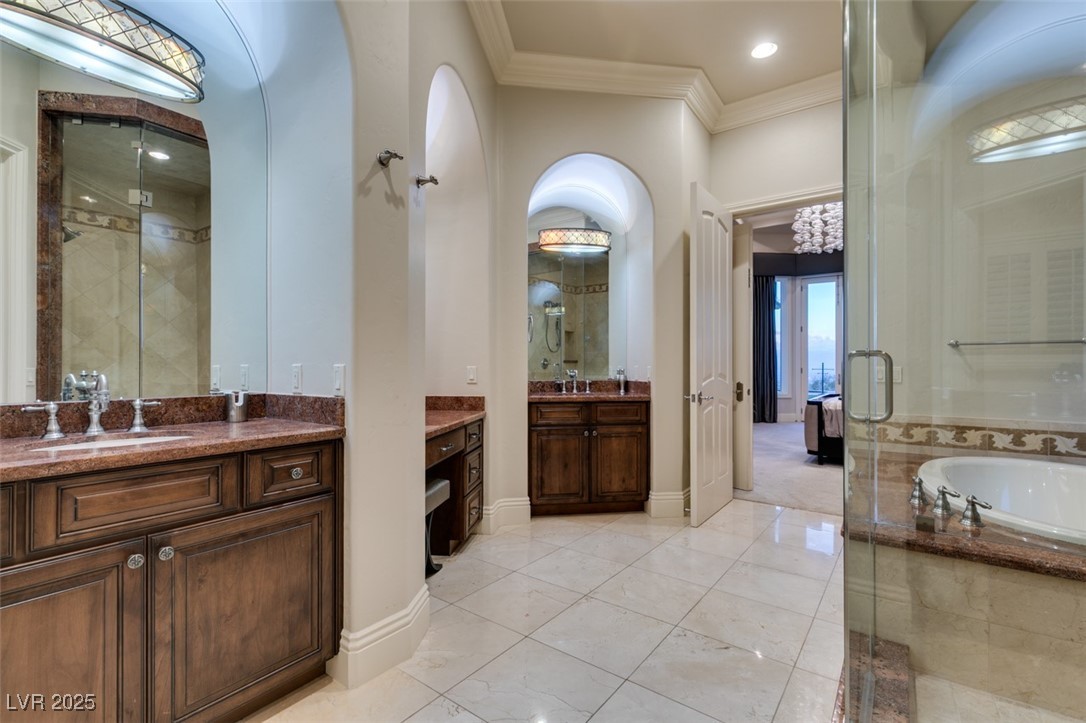 4 Awbrey Court Henderson, NV 89052 - Photo 41 of 72 Full bath featuring a garden tub, two vanities, a stall shower, and ornamental molding