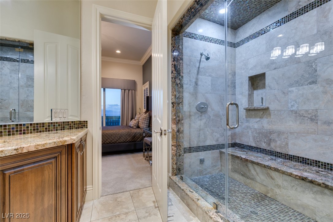 4 Awbrey Court Henderson, NV 89052 - Photo 47 of 72 Ensuite bathroom with a shower stall, light tile patterned flooring, vanity, and crown molding