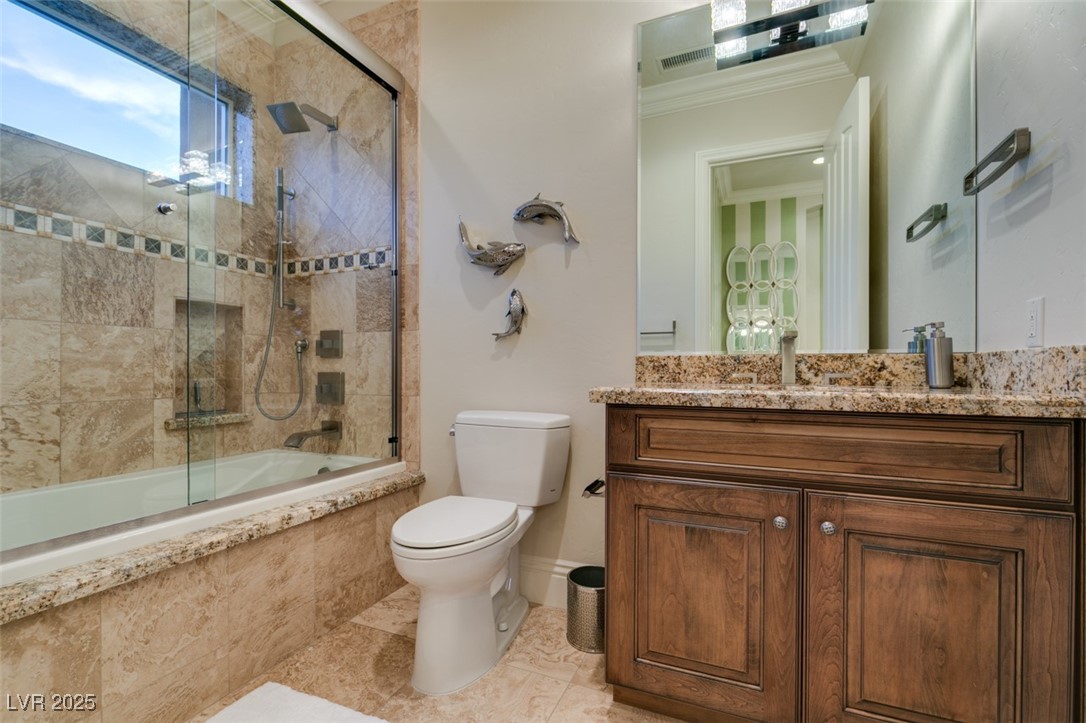 4 Awbrey Court Henderson, NV 89052 - Photo 51 of 72 Bathroom featuring tiled shower / bath combo, vanity, light tile patterned flooring, and crown molding