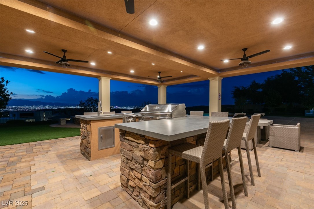 4 Awbrey Court Henderson, NV 89052 - Photo 55 of 72 Patio at night with area for grilling, ceiling fan, and a patio