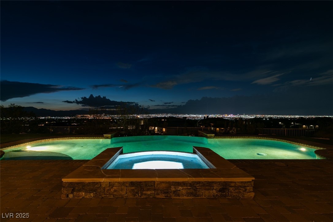 4 Awbrey Court Henderson, NV 89052 - Photo 56 of 72 Pool at twilight with a patio and a pool with connected hot tub