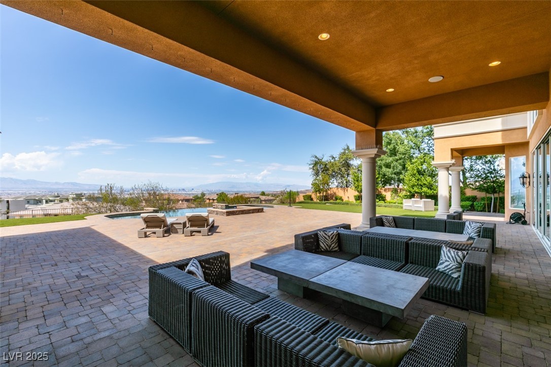4 Awbrey Court Henderson, NV 89052 - Photo 64 of 72 View of patio / terrace with an outdoor living space, an outdoor pool, a mountain view, and a jacuzzi