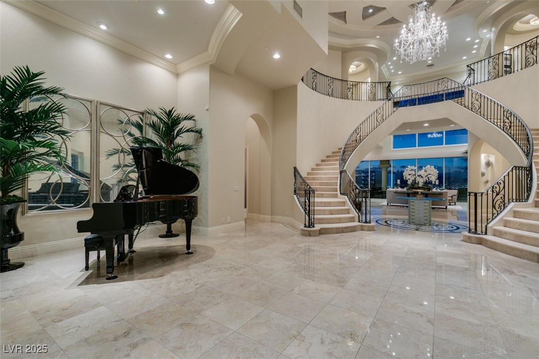 4 Awbrey Court Henderson, NV 89052 - Photo 7 of 72 Building lobby featuring stairway, recessed lighting, crown molding, and a towering ceiling