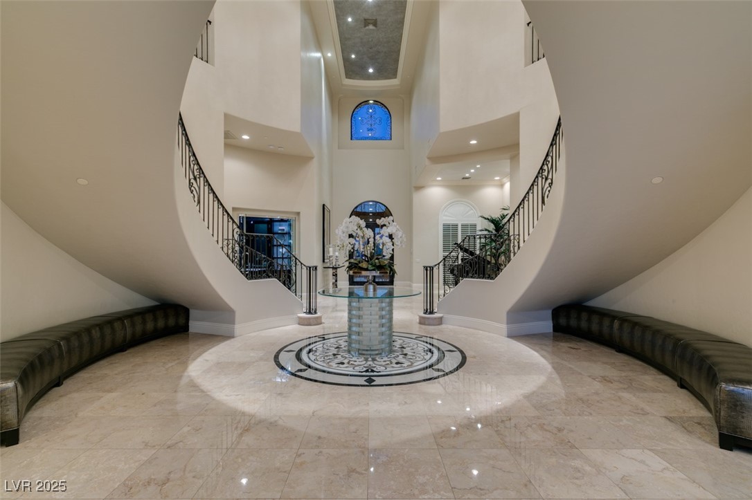 4 Awbrey Court Henderson, NV 89052 - Photo 9 of 72 Foyer featuring stairway, a towering ceiling, light marble finish flooring, and recessed lighting