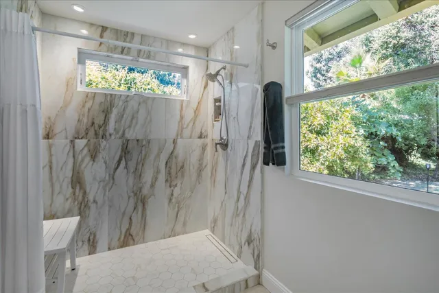a view of a bathroom with a shower and a tub