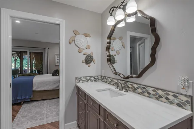 a en suite bathroom with a double vanity sink and a mirror