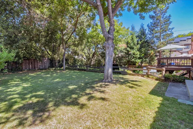 a view of a swimming pool with a patio and a yard