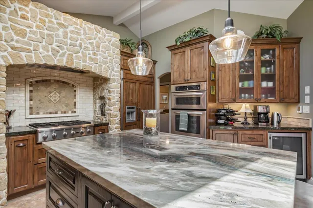 a kitchen with stainless steel appliances granite countertop a sink and cabinets