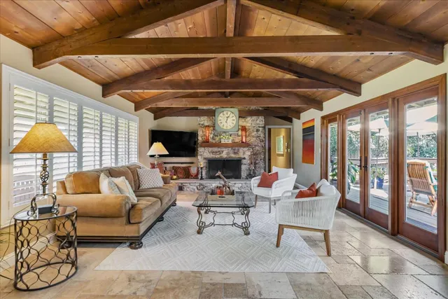 a living room with fireplace furniture and a large window