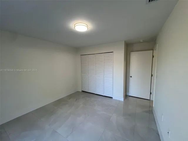 an empty room with closet area