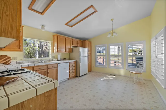 a kitchen with stainless steel appliances a stove sink and cabinets