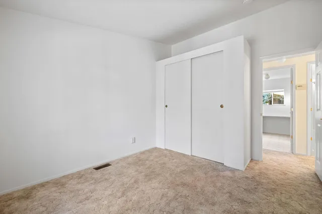 a view of an empty room with a fan