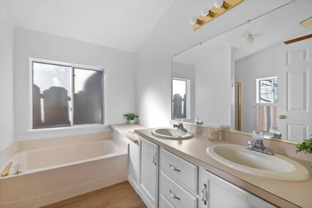 a view of a porch with plants and wooden fence