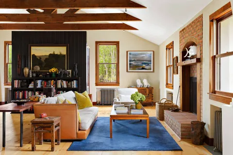 a bedroom with a bed a bookshelf and a window