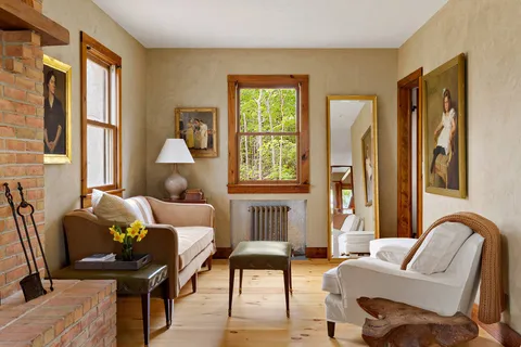 a view of a workspace with furniture and window