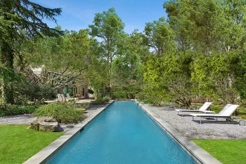 a view of a backyard with swimming pool