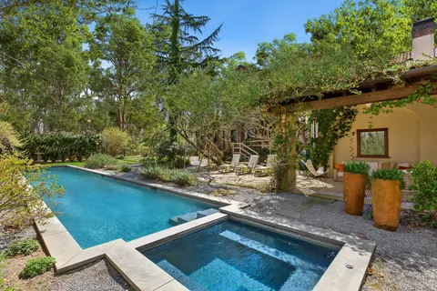 a room with a table chairs and a refrigerator