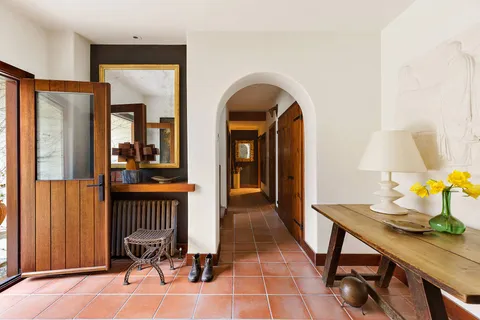 a view of a hallway with furniture and front door