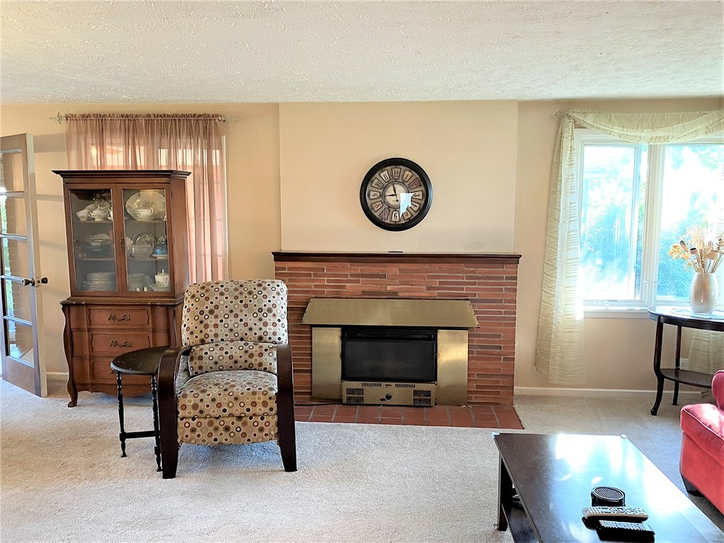 1560 Westfall Road Brighton, NY 14618 - Photo 10 of 40 Beautiful wood burning fireplace with brick surrou