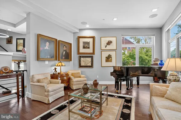 a living room with fireplace furniture and a large window