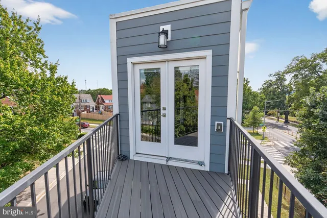 a view of a livingroom with wooden floor and a flat screen tv