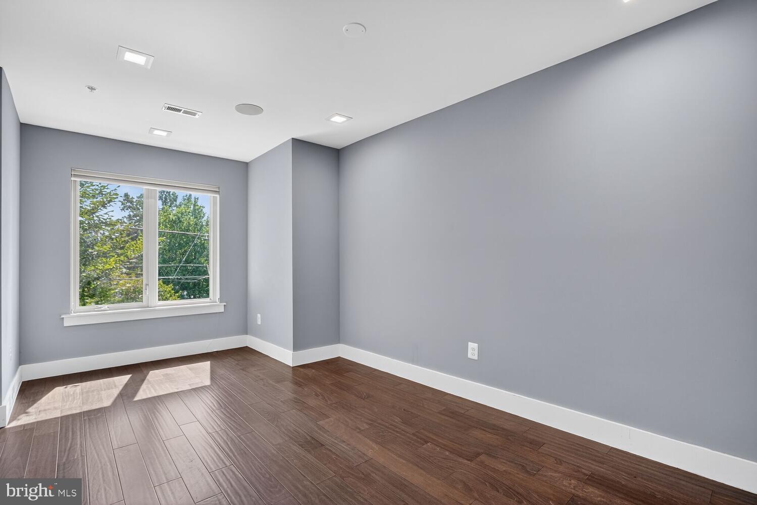 5700 Blair Road Northeast Washington, DC 20011 - Photo 23 of 45 a view of an empty room with wooden floor and a window