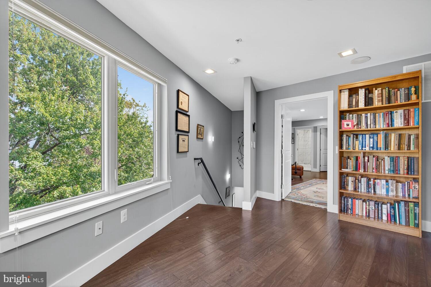5700 Blair Road Northeast Washington, DC 20011 - Photo 27 of 45 a living room with wooden floor and a book shelf