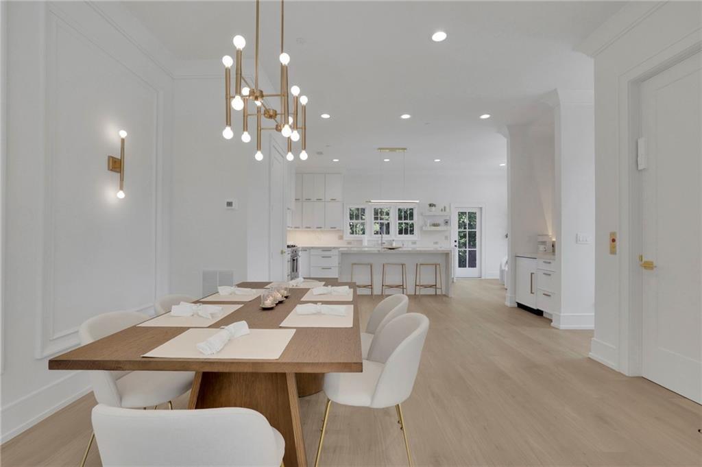 343 Sugarview Road Sugar Hill, GA 30518 - Photo 11 of 40 a view of a dining room with furniture and chandelier