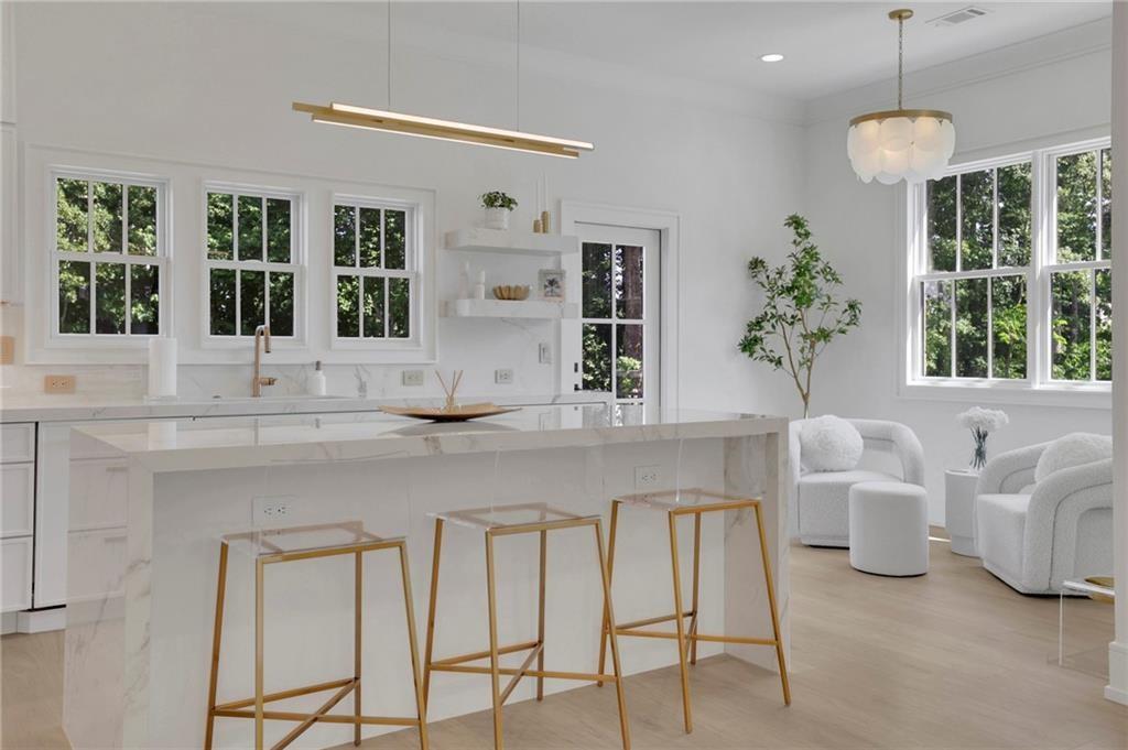 343 Sugarview Road Sugar Hill, GA 30518 - Photo 16 of 40 a kitchen with white cabinets and window
