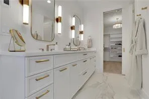 a bathroom with a double vanity sink mirror and
