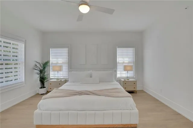 a spacious bedroom with a bed and window